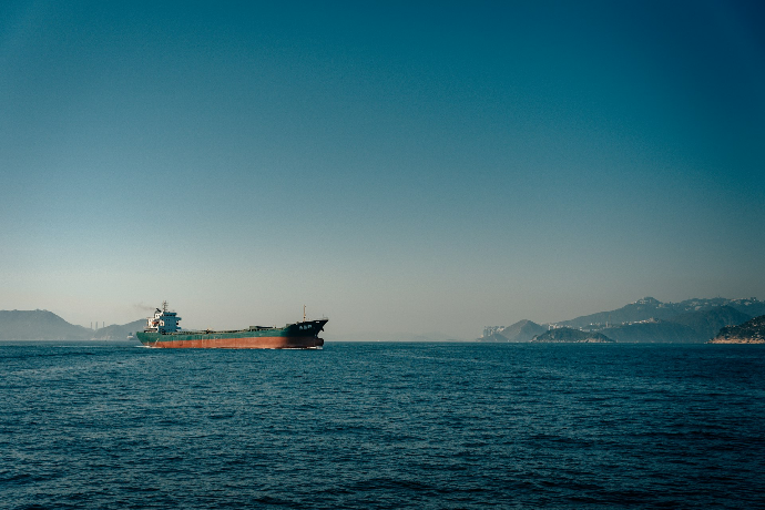 red ship on sea under blue sky during daytime